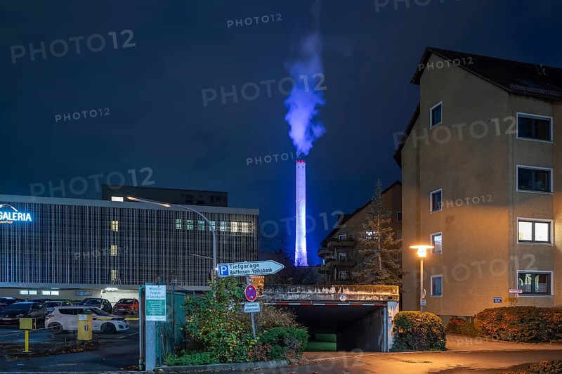 Glowing blue chimney from the CHP plant in the evening, Erlangen.Mittelfranken, Bavaria, Germany