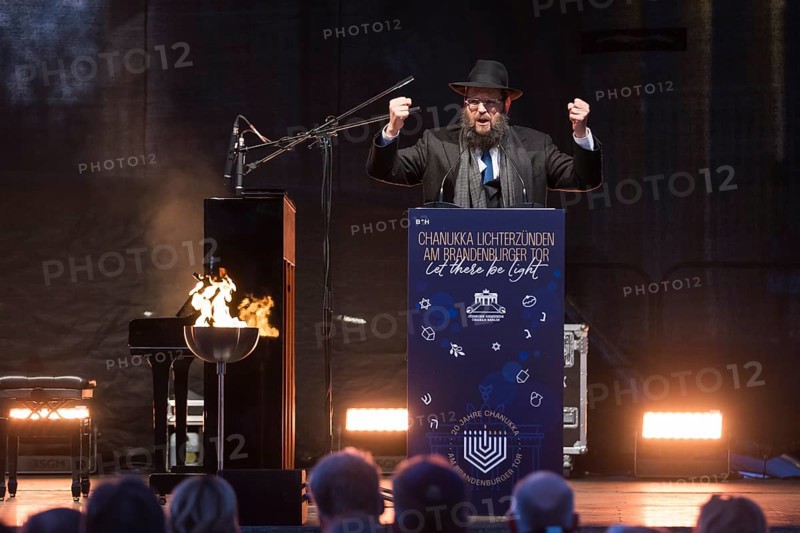 Yehuda Teichtal (Rabbi of the Chabad-Lubavitch movement) speaks at the lighting of lights to mark 20 years of Hanukkah in front of the Brandenburg Tor tor, Berlin, 17 December 2025