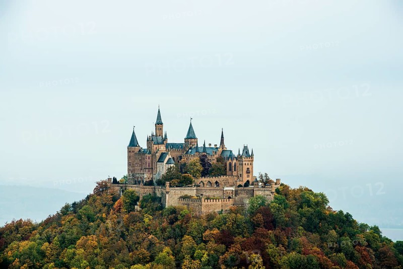 Castle and autumnal forest, Hohenzollern Castle, Hechingen, Swabian Jura, Baden-Württemberg, Germany