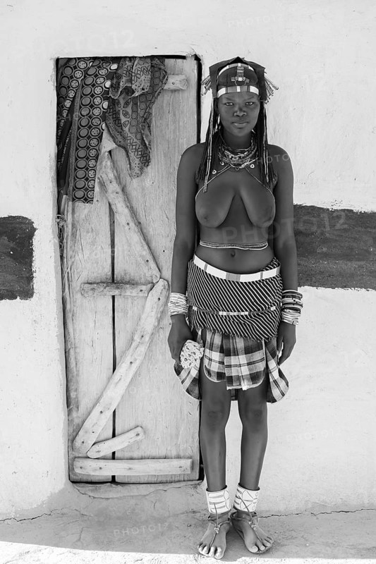 Black and white, portrait, brightly decorated woman of the Hakaona tribe, also Havakona or Hakawona, near Opuwo, Kunene, Namibia
