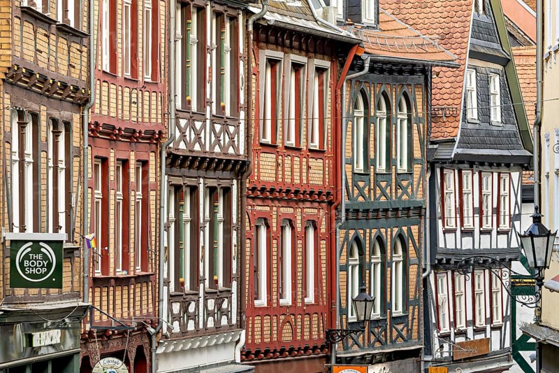 Detailed, colorful half-timbered facades in a cramped old town alleyway, The historic old town of Marburg an der Lahn in Hesse