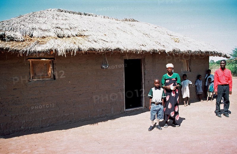 In a World Vision project, friends and neighbors have gathered on the occasion of a godfather's visit, Nyabubinza, Tanzania, Africa, June 2000, vintage, retro, old, historic