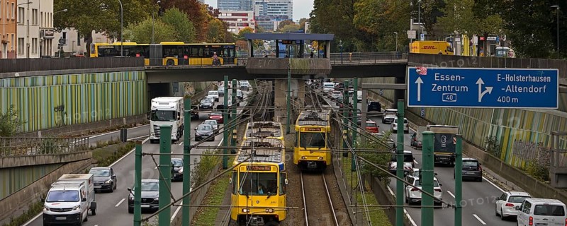Lots of traffic on the A 40 motorway on four lanes and two subways on two lanes and a bus on the bridge, infrastructure, Essen, Ruhr area, North Rhine-Westphalia, Germany
