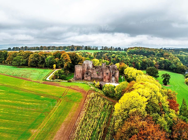 Autumn Colours over ruins of Goodrich Castle and River Wye from a drone, Goodrich, Herefordshire, England, United Kingdom