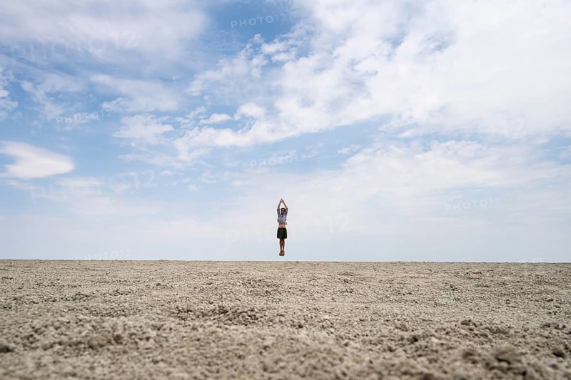 Symbolic picture, abstract, man jumping on the Etosha pan, salt pan, Etosha National Park, Namibia