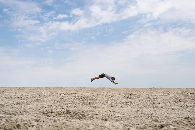 Abstract, man jumping horizontally at the Etosha pan, salt pan, Etosha National Park, Namibia