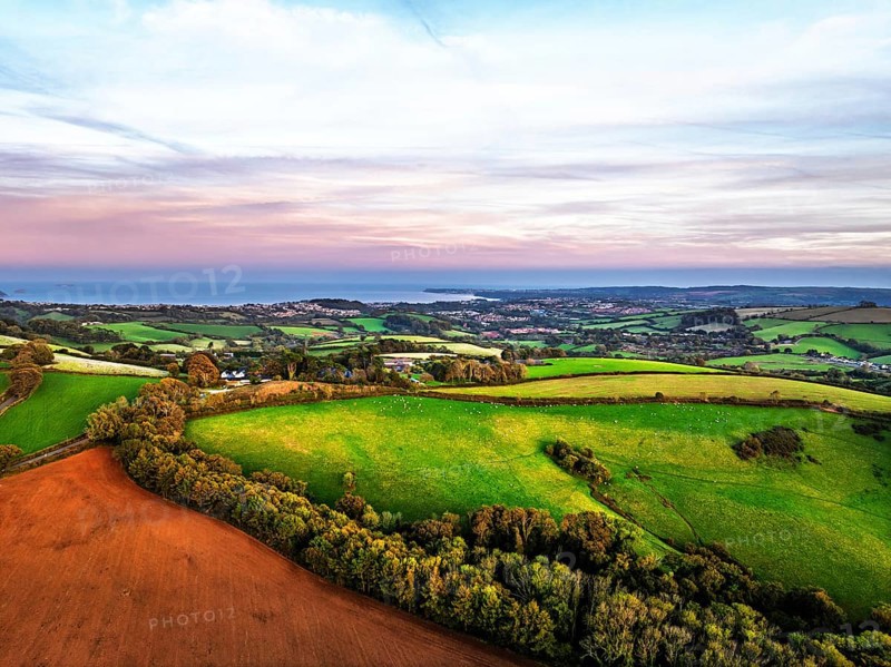 Sunset of Devon Farms and Fields over Berry Pomeroy from a drone, Totnes, England, United Kingdom