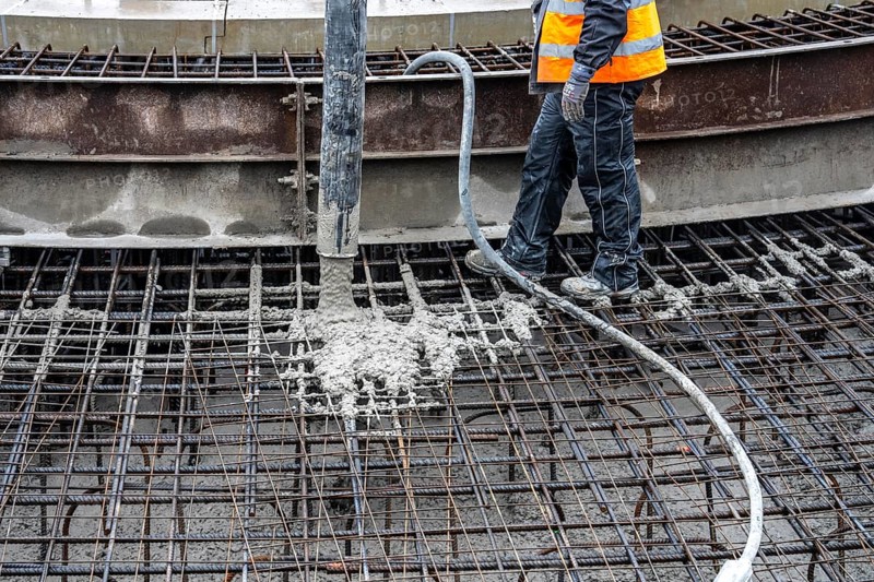 Concreting, concreting the foundation of a wind turbine, concrete pump hose, more than 600 cubic meters of concrete will be pumped into the foundation for over 7 hours, over 100 tons of reinforcing steel have been used, the wind turbine will have a hub height of 160 meters, part of a new wind farm in Sauerland, near Balve, North Rhine-Westphalia, Germany