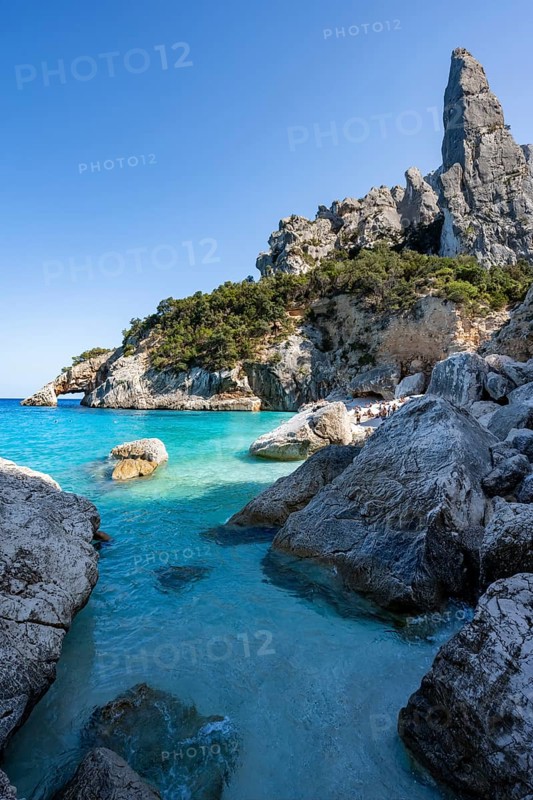 Light blue clear sea on a dream beach on Cala Goloritzé, picturesque rocky coast, steep coast with rock pin L'Aguglia, Golfo di Orosei, Baunei, Sardinia, Italy
