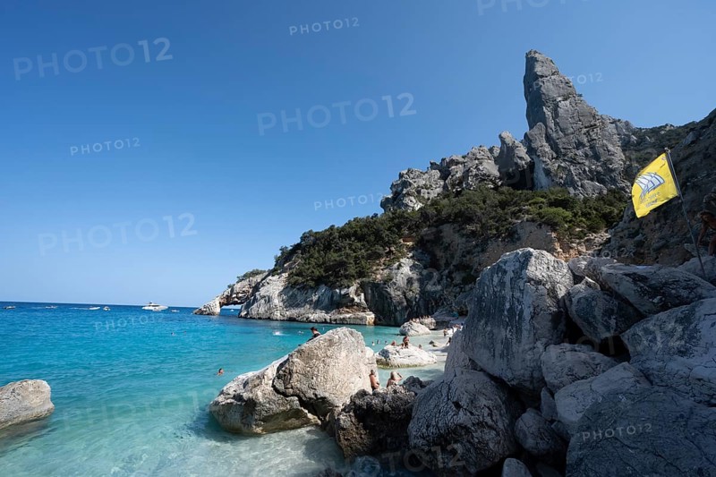 Light blue clear sea on a dream beach on Cala Goloritzé, picturesque rocky coast, steep coast with rock pin L'Aguglia, Golfo di Orosei, Baunei, Sardinia, Italy