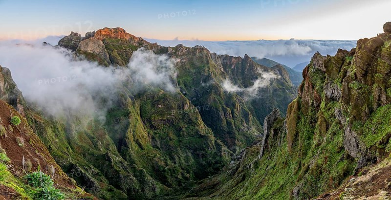 Sunrise at Pico do Arieiro, clouds of fog pass over mountain peaks, hiking trail PR1, Madeira, Portugal