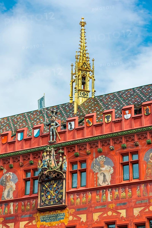 Exterior view with a magnificent clock at the Red Town Hall, Market Square, Basel