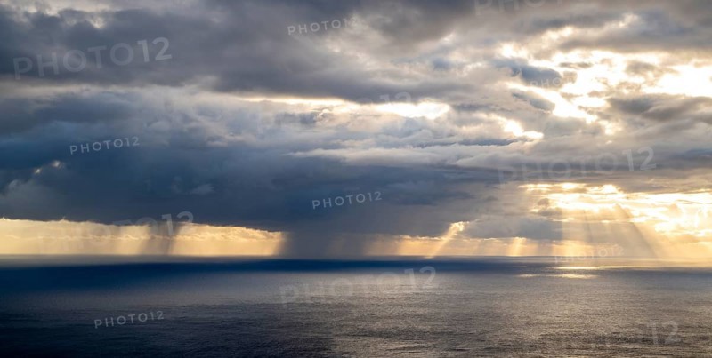 Sunset, sun rays over sea, dark rain cloud, rain, Madeira, Portugal