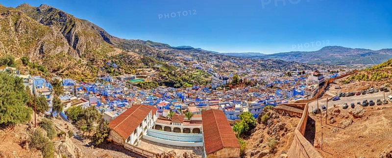 Panoramic picture of a city with distinctive blue buildings and mountainous surroundings, Morocco, Chefchaouen