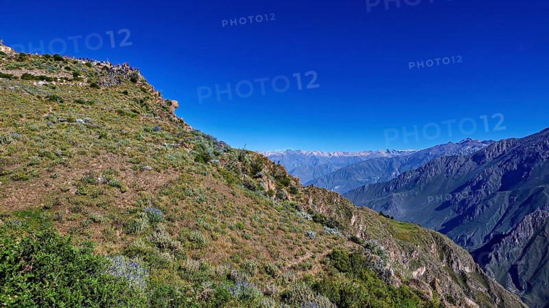Landscape with a wide view of a mountainous landscape under clear, blue sky, The mountains and valleys of the Colca Canyon in Peru