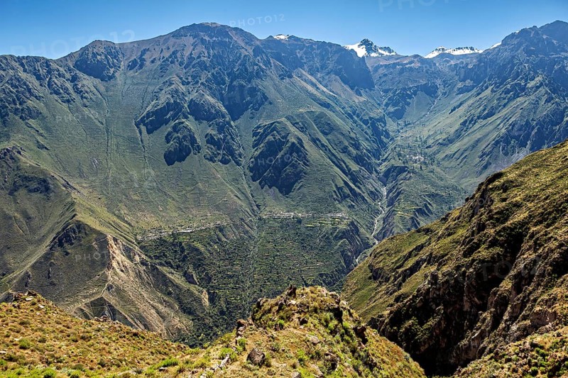 Impressive mountain landscape with deep valleys and snow-capped peaks in the distance, The mountains and valleys of the Colca Canyon in Peru