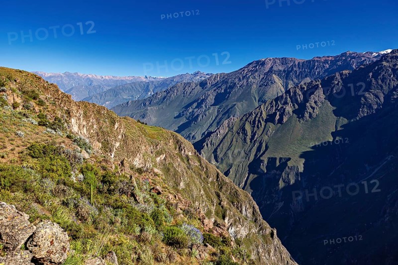 Clear sky with a wide panorama of mountains and deep gorge, The mountains and valleys of the Colca Canyon in Peru