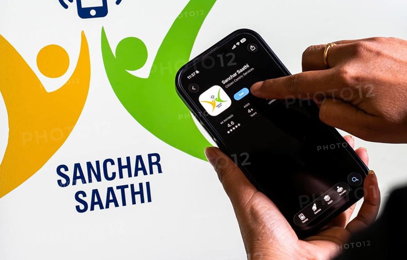 In this photo illustration, a person downloads the Sanchar Saathi mobile application on an iPhone, in New Delhi, India on 3 December 2025. Sanchar Saathi is officially developed and operated by the Department of Telecommunications (DoT), Government of India as part of its citizen-protection and telecom-security initiative