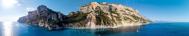 Panorama, picturesque rocky coast, cliffs with L'Aguglia pinnacle, blue sea and Cala Goloritzé beach, aerial view, Golfo di Orosei, Baunei, Sardinia, Italy