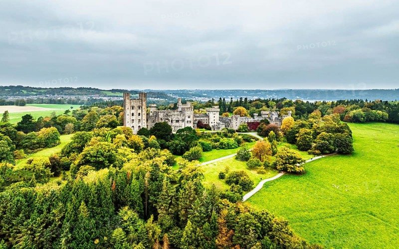 Autumn colours over Penrhyn Castle and Garden from a drone, Llandygai, Bangor, Gwynedd, North Wales, UK