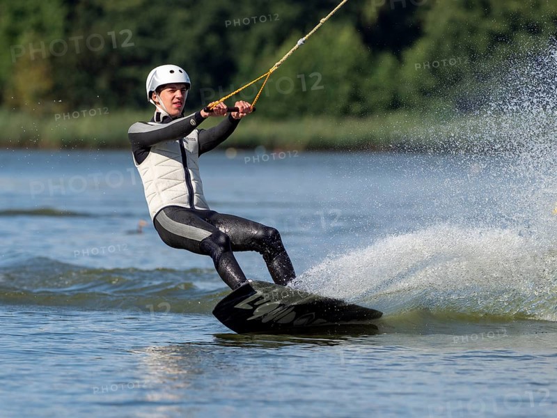 Young man with wakeboard, sporty on water, athletic model, active water sports, wake park