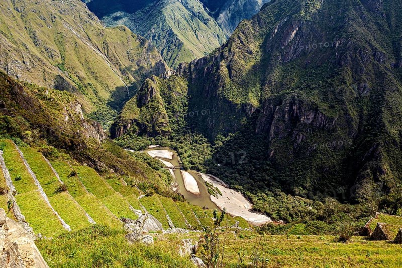 Green mountain terraces lead down into the valley, The Urubamba Valley near Machu Picchu in Peru
