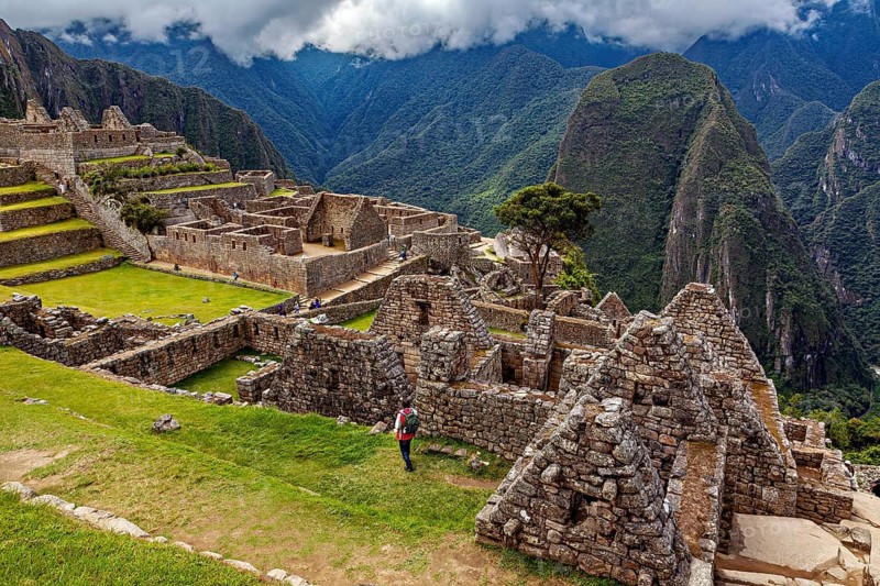 View of the extensive ruins of Machu Picchu surrounded by impressive mountain scenery, The ruins of the Inca city of Machu Picchu in Peru