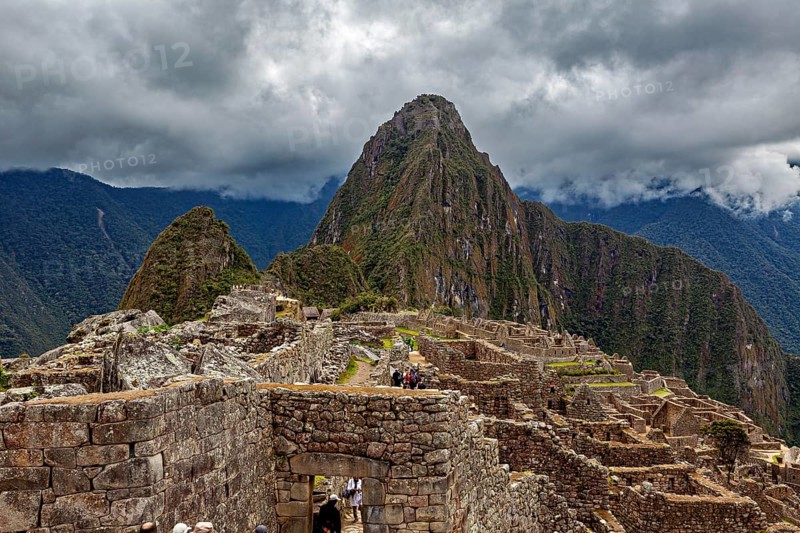 Machu Picchu with dramatic cloudscape and visible mountain, The ruins of the Inca city of Machu Picchu in Peru