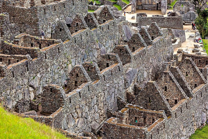 Detailed stone structures and walls in a historic site landscape, the ruins of the Inca city of Machu Picchu in Peru