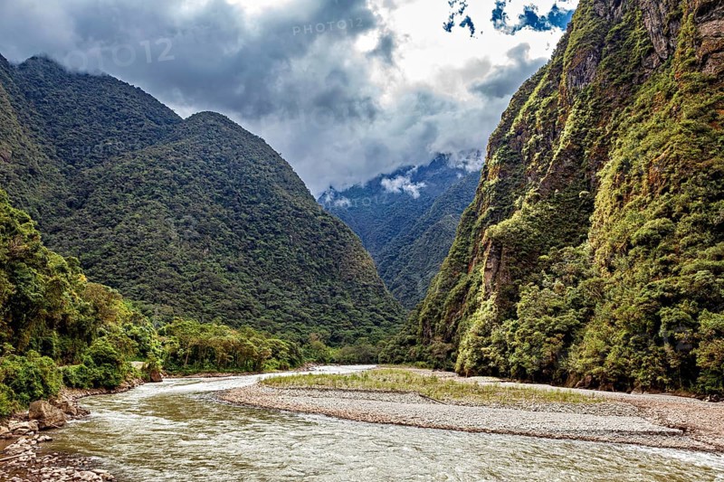 Winding river path through a lush green valley, The Urubamba Valley near Machu Picchu in Peru