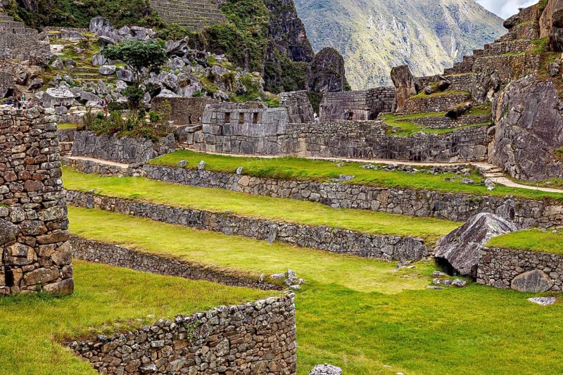 Inca stone walls and green terraces in the midst of a mountainous landscape near Machu Picchu, The ruins of the Inca city of Machu Picchu in Peru