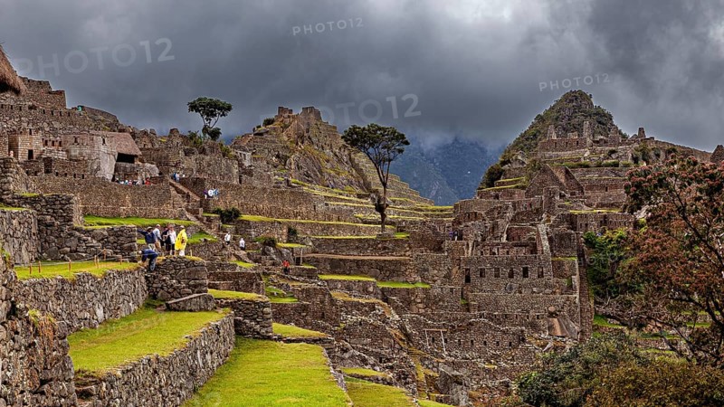 Detailed view of Machu Picchu with impressive ruins and thick cloud cover in the background, The ruins of the Inca city of Machu Picchu in Peru