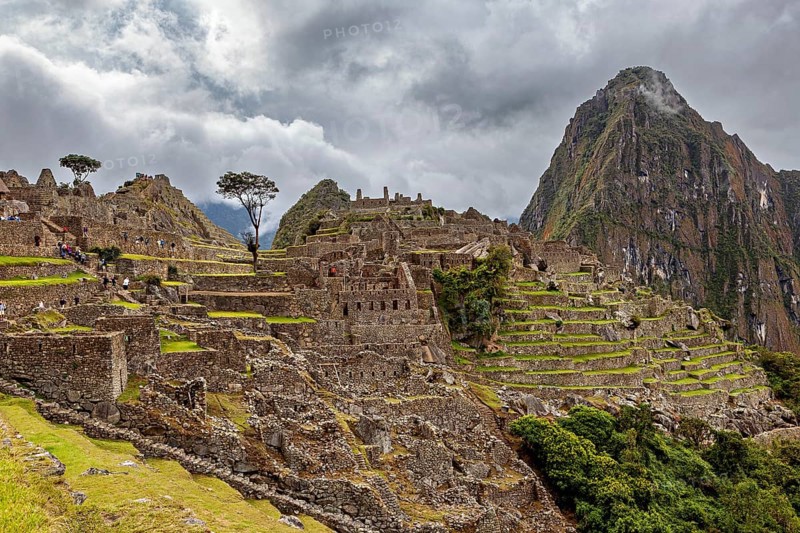 Historic ruins of Machu Picchu with impressive mountain scenery and clouds, The ruins of the Inca city of Machu Picchu in Peru