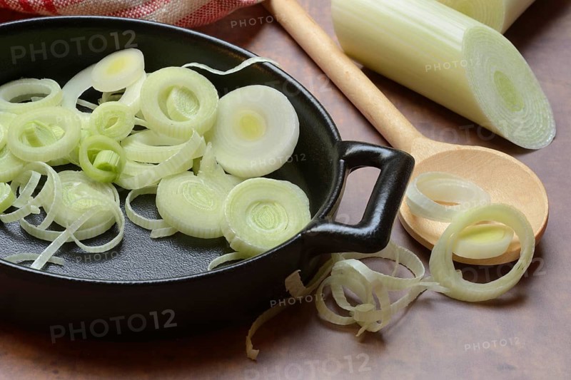 Leeks, leek rings in pan with cooking spoon, leek