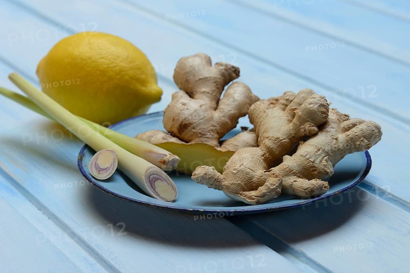 Ginger tubers with lemongrass on plate, lemon