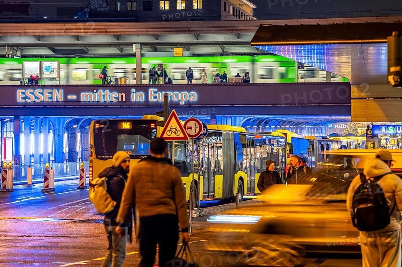The main train station in Essen, blue illuminated underpass, bus station, am Europaplatz, train on the platform, pedestrian crossing, North Rhine-Westphalia, Germany