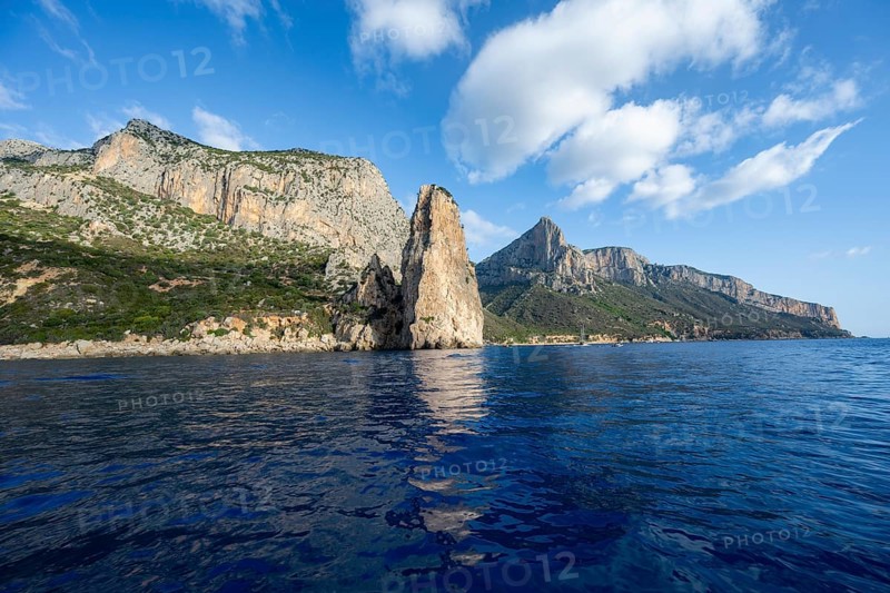 Picturesque rocky coast, cliffs with Pedra Longa pinnacle, blue sea, Golfo di Orosei, Baunei, Sardinia, Italy