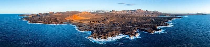 Coast with lava fields, volcanic landscape near Los Hervideros with red volcano Montaña Bermeja, in the evening light, aerial view, Lanzarote, Canary Islands, Spain