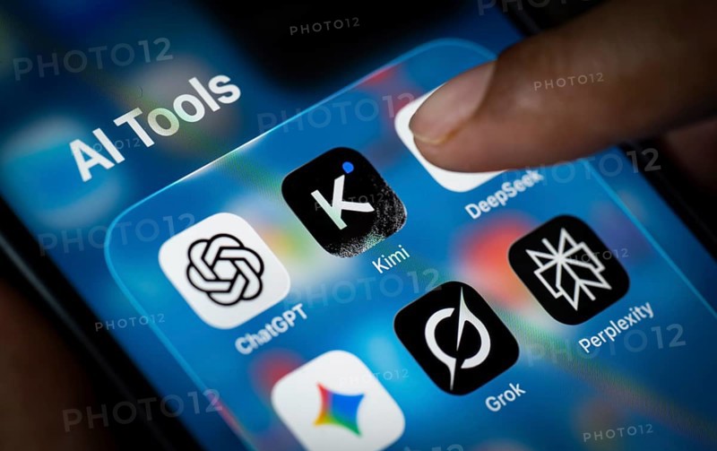 In this photo illustration, a person uses the Kimi AI chatbot on a smartphone while the KIMI logo is displayed on a screen in the background, in New Delhi, India on 20 November 2025. Kimi AI is a Chinese artificial intelligence chatbot and assistant developed by Moonshot AI, a fast-growing tech company in China