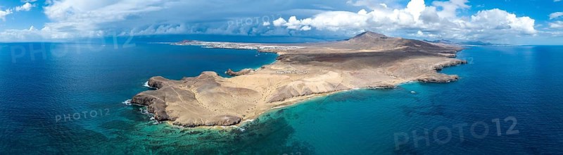 Headland and blue sea, coastal landscape, arid landscape of Los Ajaches Natural Park, aerial view, Lanzarote, Canary Islands, Spain