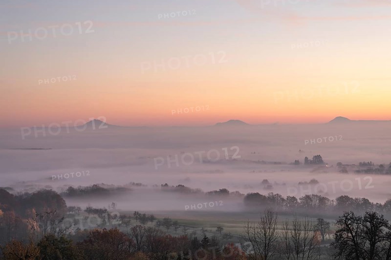 Three Kaiserberge mountains in golden morning light, Hohenstaufen, Aichelberg. Spectacular dawn over the foggy foothills of Baden-Württemberg