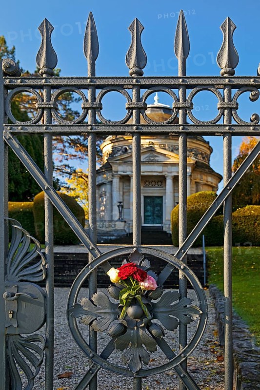 Roses at the fence door of the Carstanjen mausoleum in the Plittersdorf district, Bonn, North Rhine-Westphalia, Germany