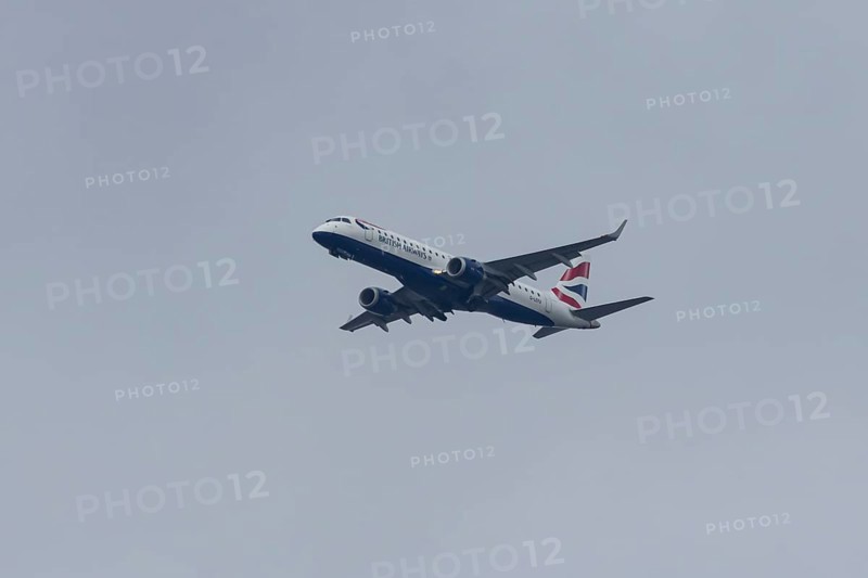 Embraer ERJ-190 jet passenger aircraft of British Airways BA CityFlyer airlines in flight on approach to London city airport, England, United Kingdom
