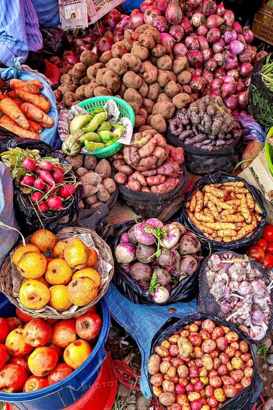 Colourful market image with a variety of fresh fruit and vegetables, including potatoes, onions and carrots, fruits and vegetables at the Rurrenabaque market in Bolivia