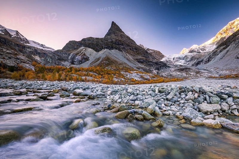 Mountain stream with autumnal larches and mountain views, Mont Mine, Ferpecle glacier, Val d'Herens, Canton of Valais, Switzerland
