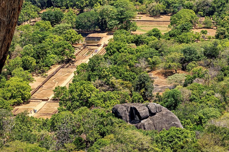 Aerial view of historic ruins and lush jungles with rock formations, the temples, dagobas, and pagodas at Lion Rock near Sigiriya in Sri Lanka