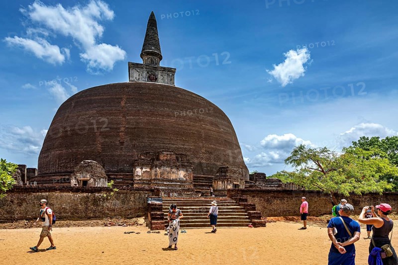 Large ancient stupa with people in the foreground on a sunny day, The temples of Polonnaruwa in Sri Lanka