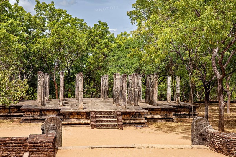 Ancient ruins with stone pillars surrounded by trees, The temples of Polonnaruwa in Sri Lanka