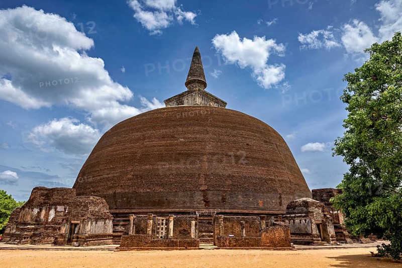 Large stupa under a cloudy sky with surrounding ancient walls, The temples of Polonnaruwa in Sri Lanka