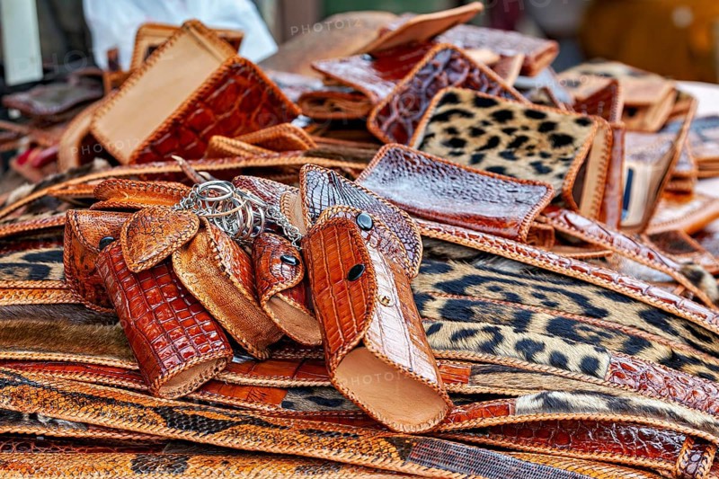 Market with brown leather accessories and eye-catching leopard patterns, leather products from poaching in the Amazon jungle near Rurrenabaque in Bolivia